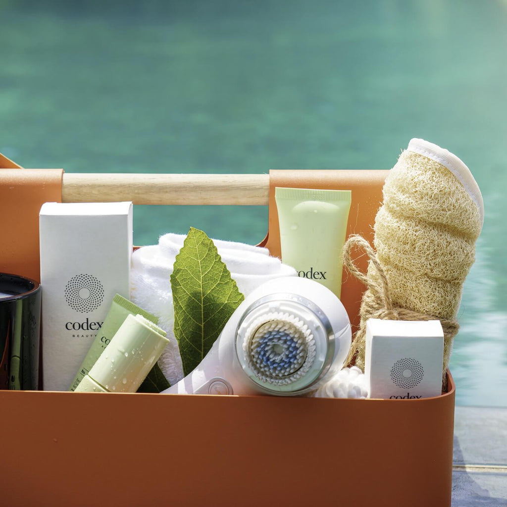 Image of Codex Labs  products sitting in a caddy basket  poolside
