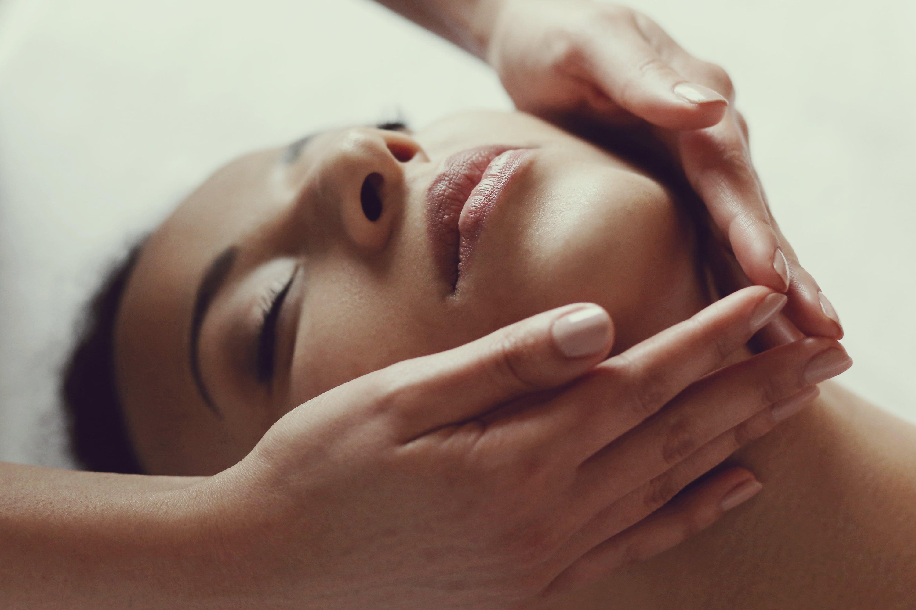 Image of a female model getting a facial massage 