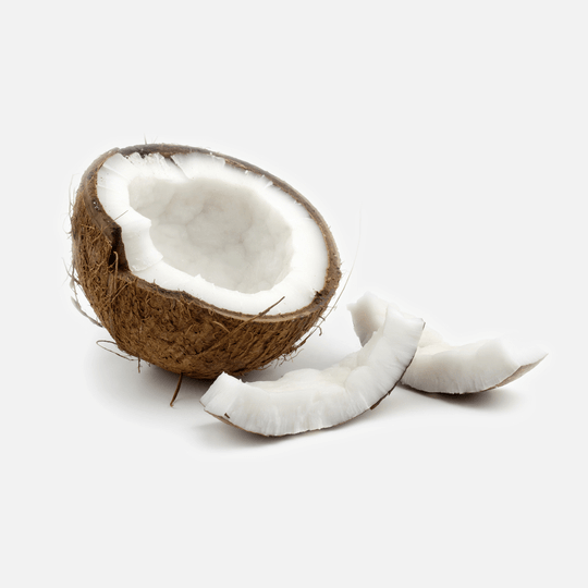 A coconut split in half on a white background