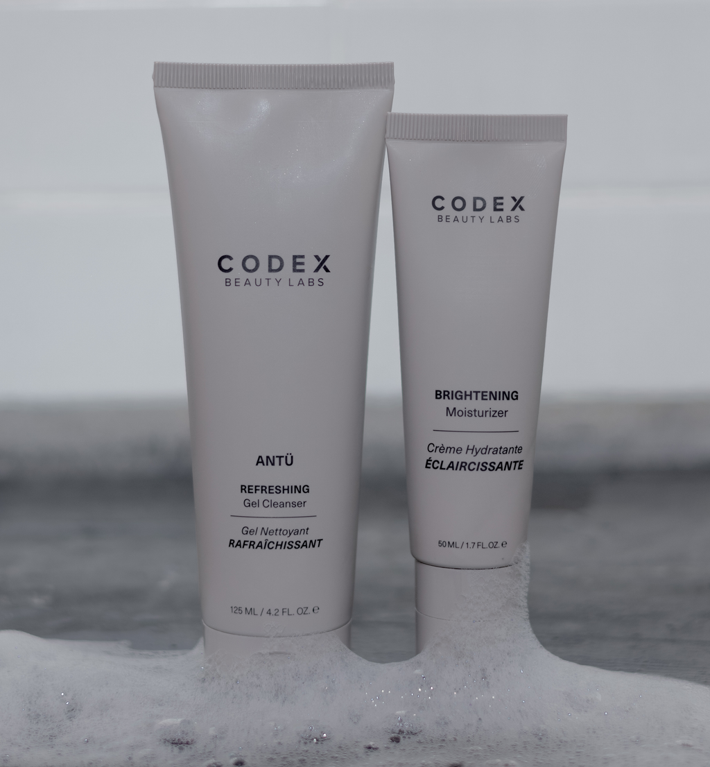 Codex Beauty Labs Antu Refreshing Gel Cleanser and Antu Brightening Moisturizer placed on the side in a bathroom