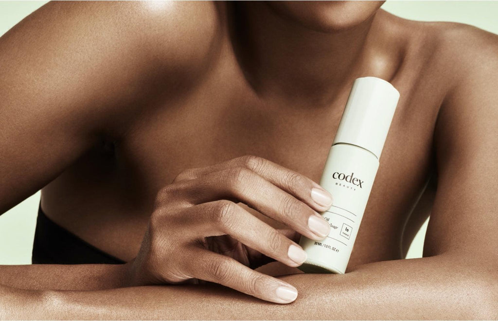 Model holding a Bia Facial Oil in their hand