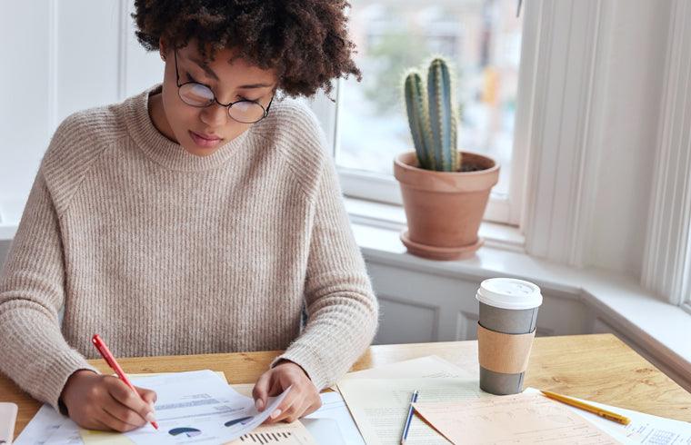 professional woman looking at notes in an office