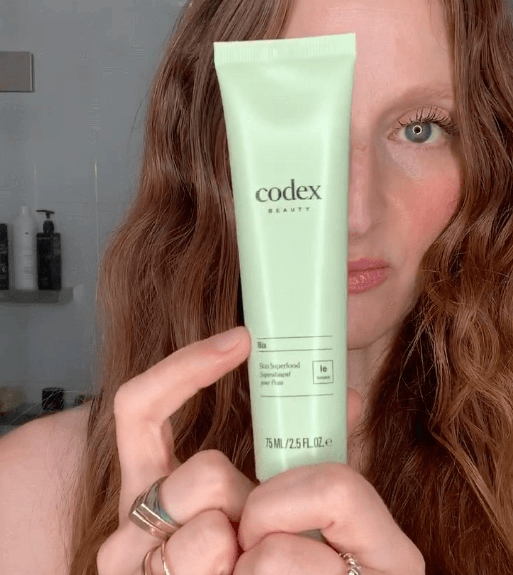 Codex Beauty Labs model holding a Bia Skin Superfood in front of their face.