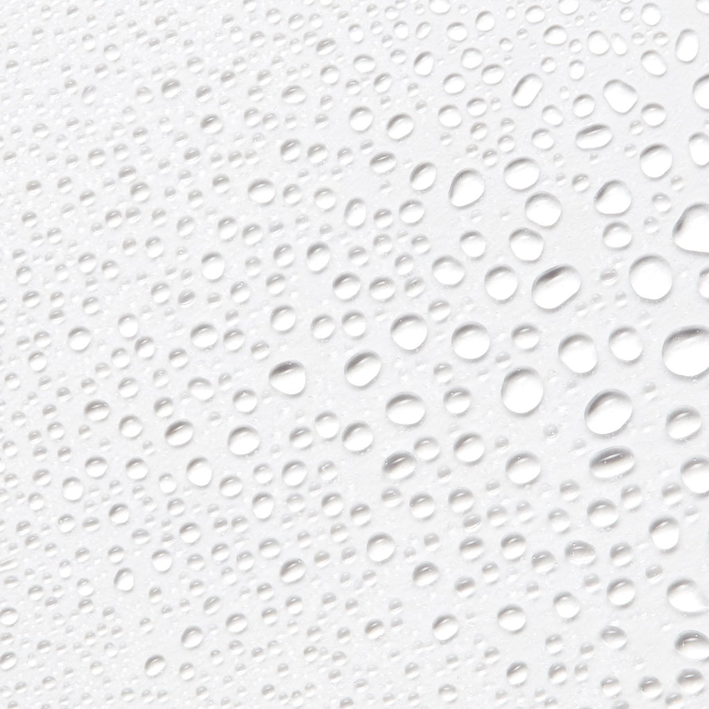 Close-up image of droplets from Antu Radiance Mist on a white background.
