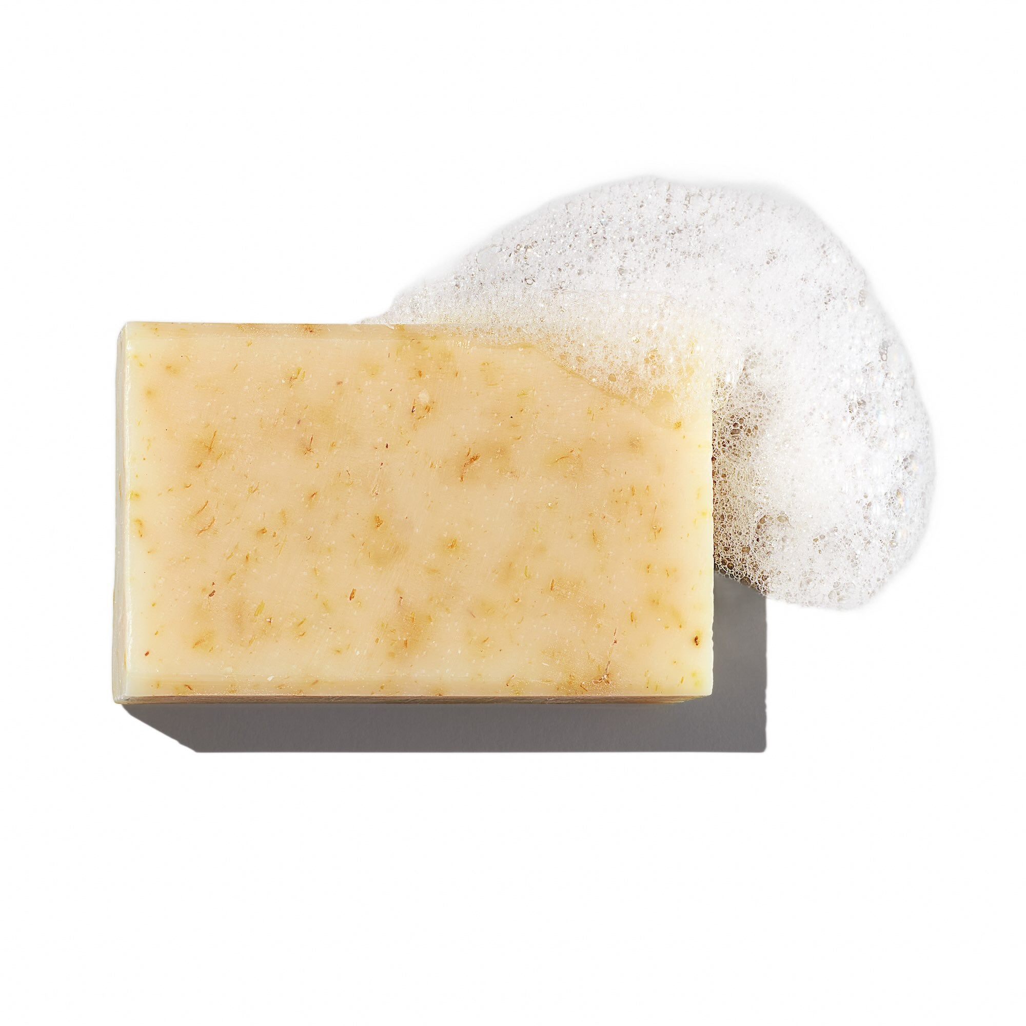 Bia unscented soap with soap bubbles on a white background.