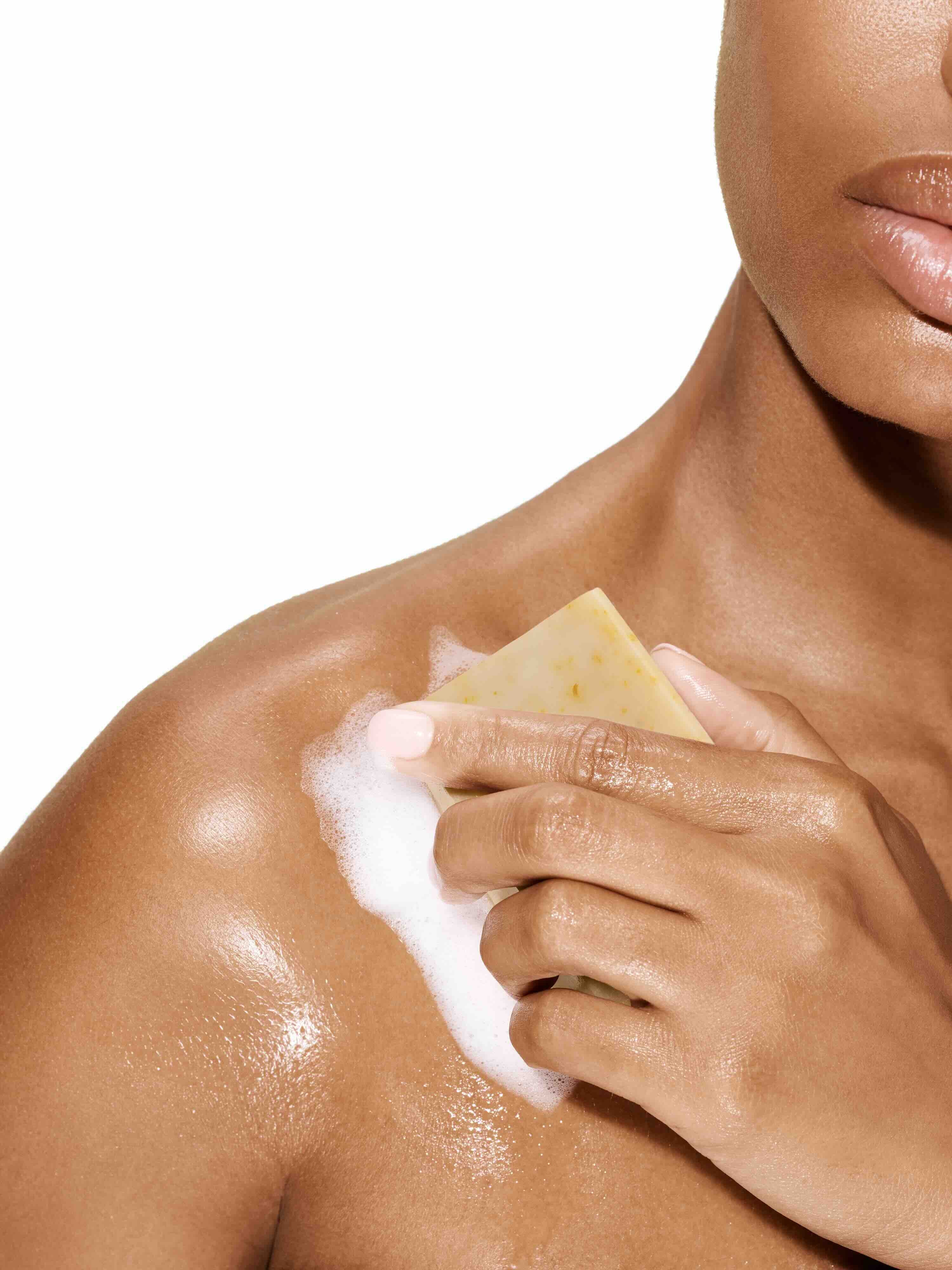Image of a model rubbing her skin with the Bia Unscented Soap
