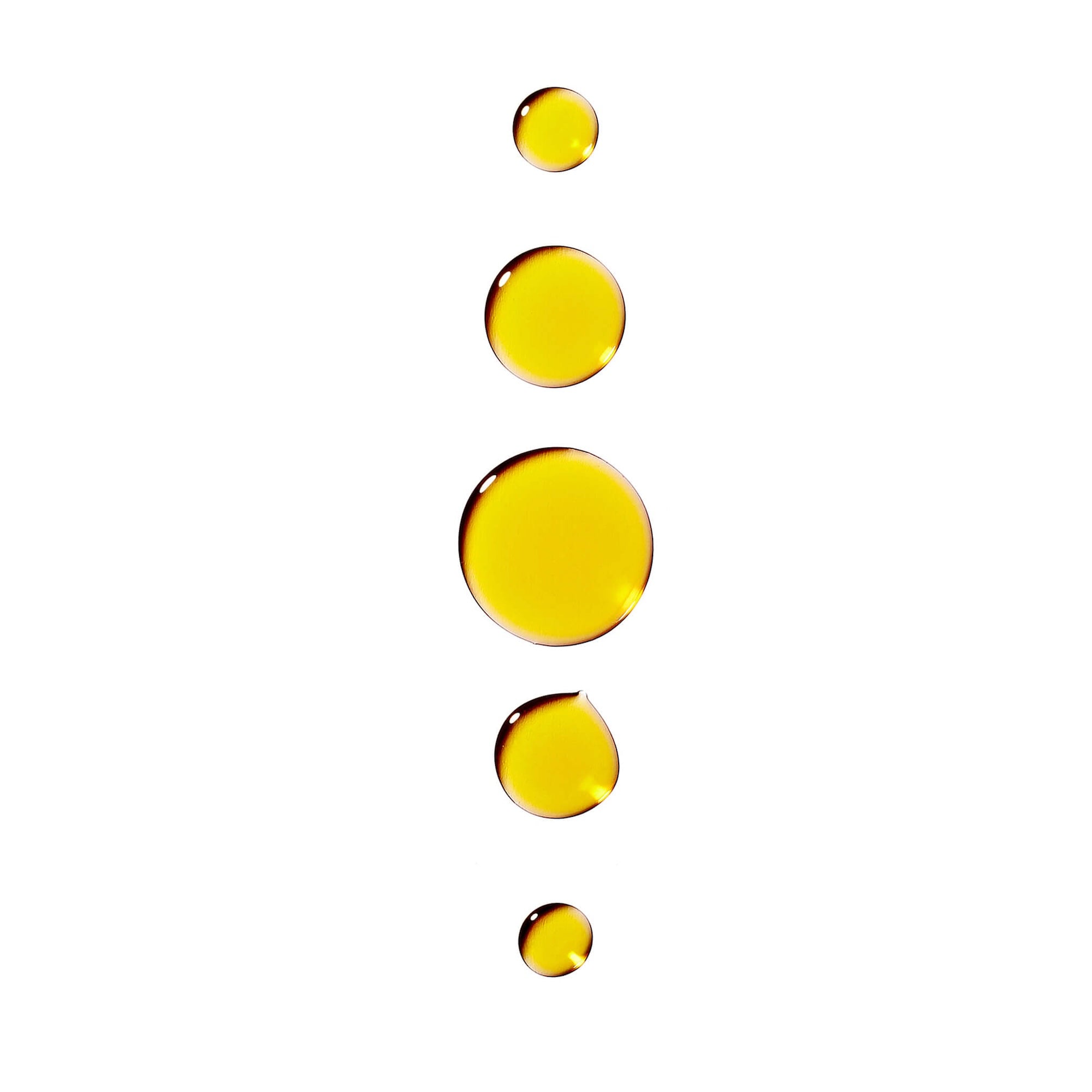 Image of drops of the Bia Nourishing Facial Oil on a white background.