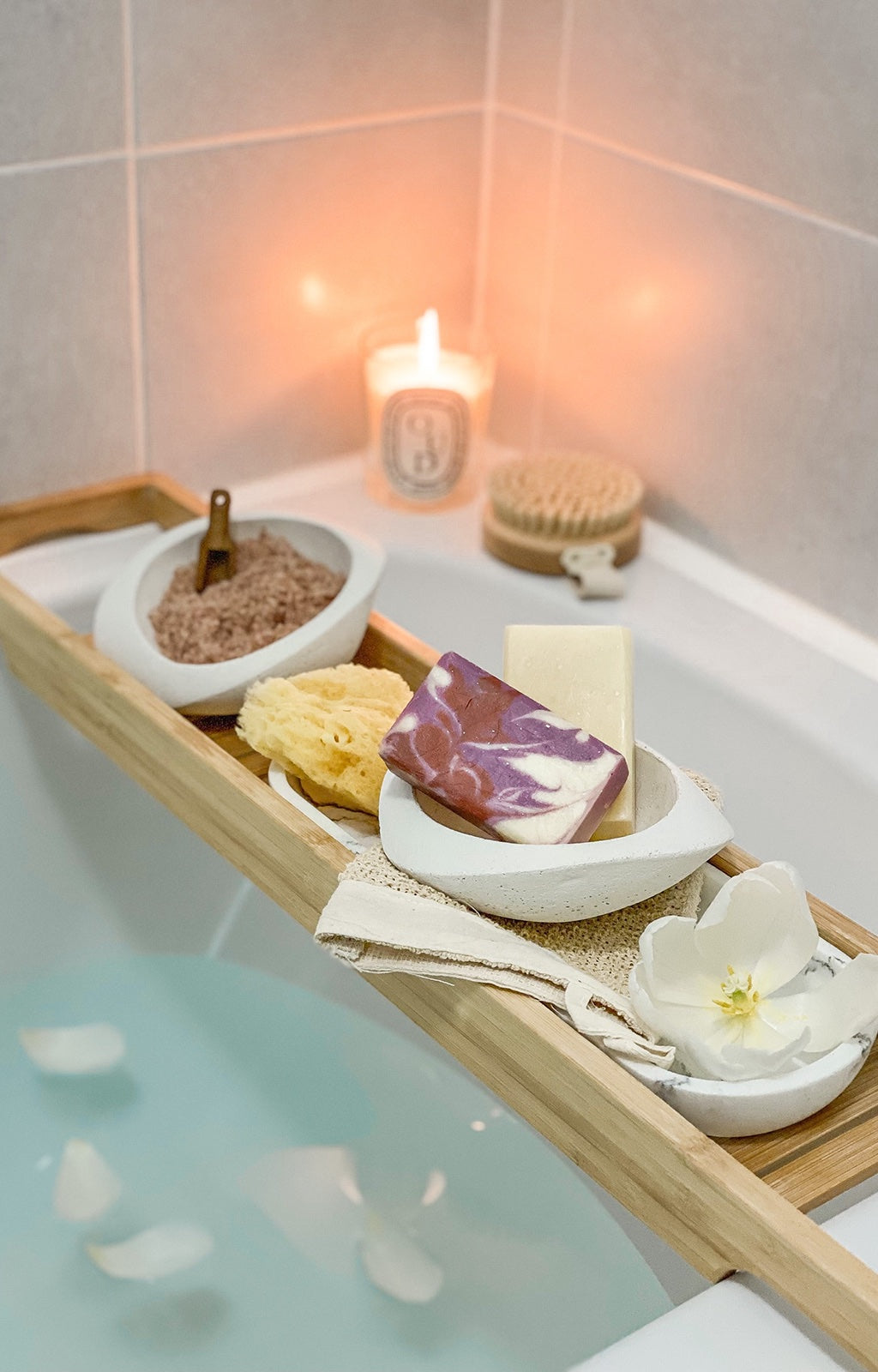 Image of bars of soap on a wooden table above a bath tub.