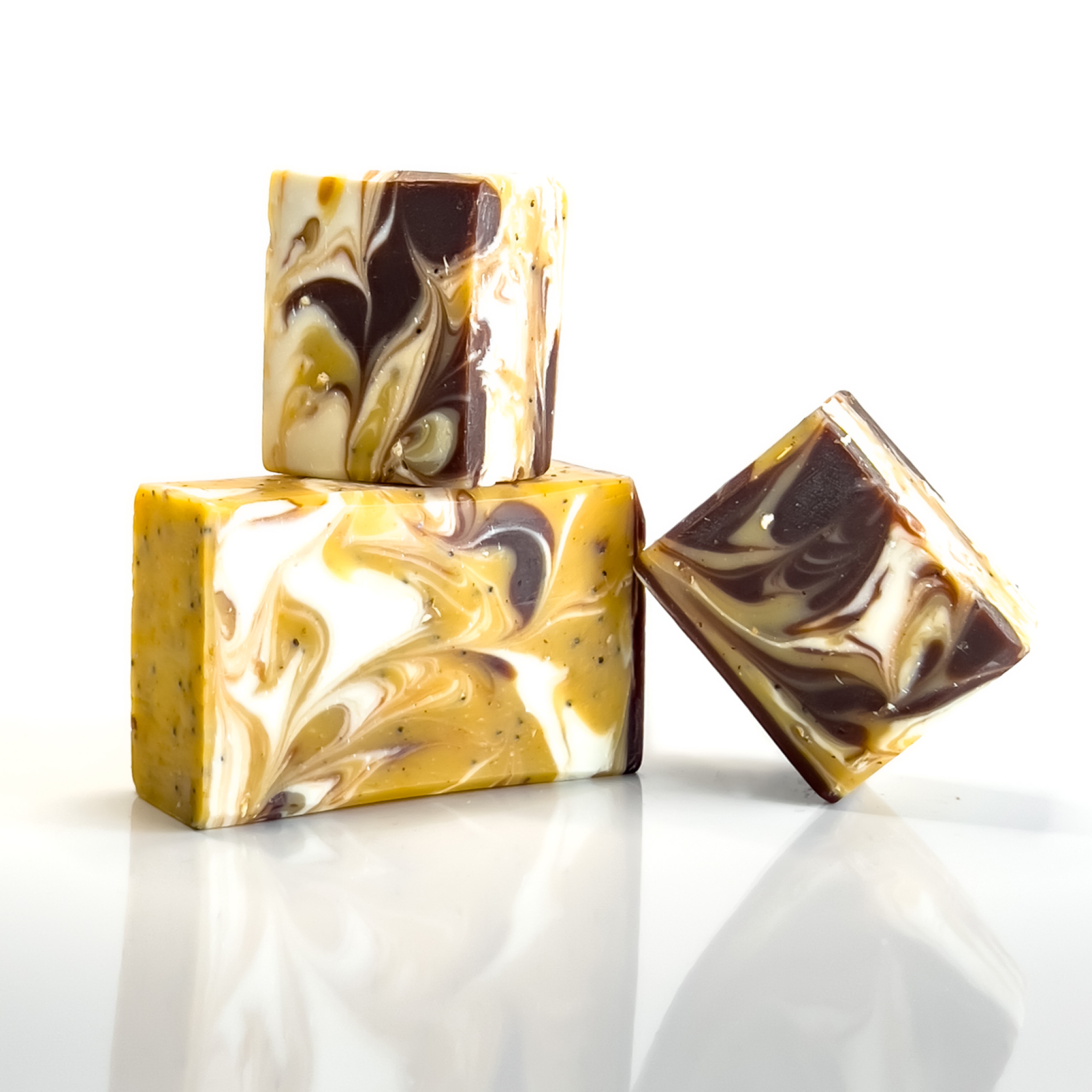 Image of 3 bars of Harvest soap stacked on top of each other next to its packaging .