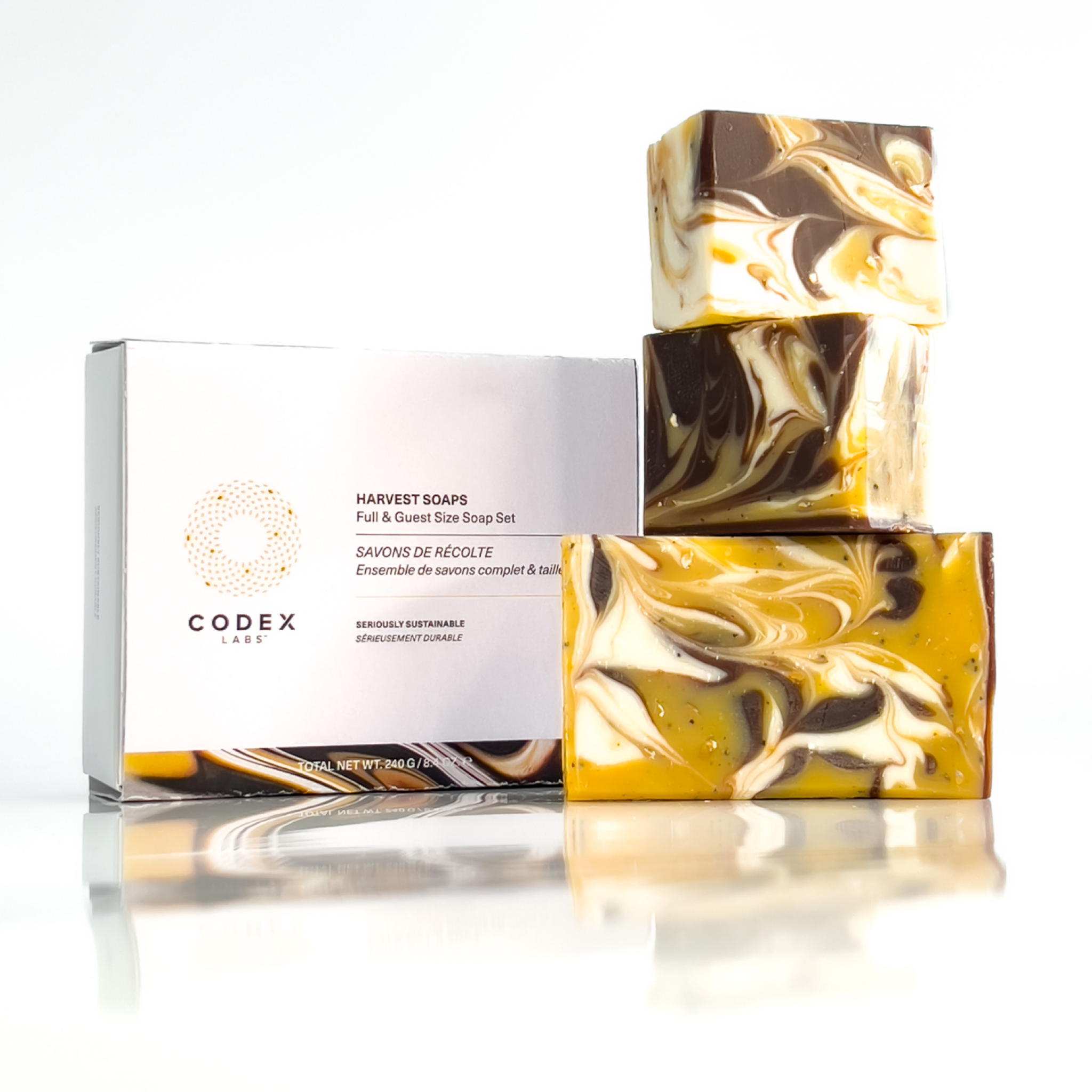Image of 3 bars of Harvest soap stacked on top of each other next to its packaging.
