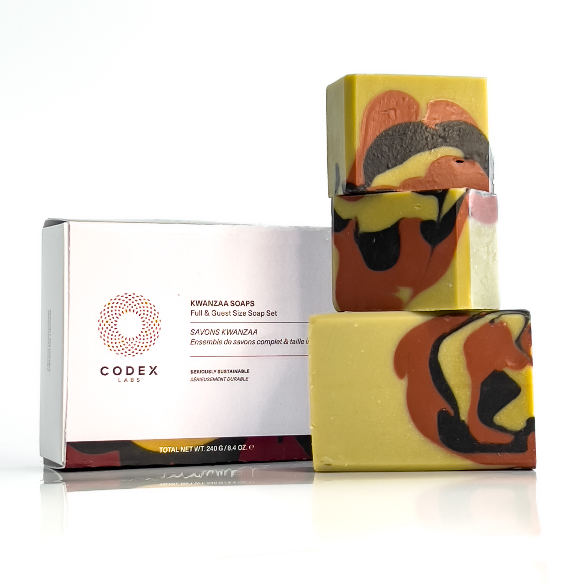 Image of 3 bars of Kwanzaa soap stacked on top of each other next to its packaging.