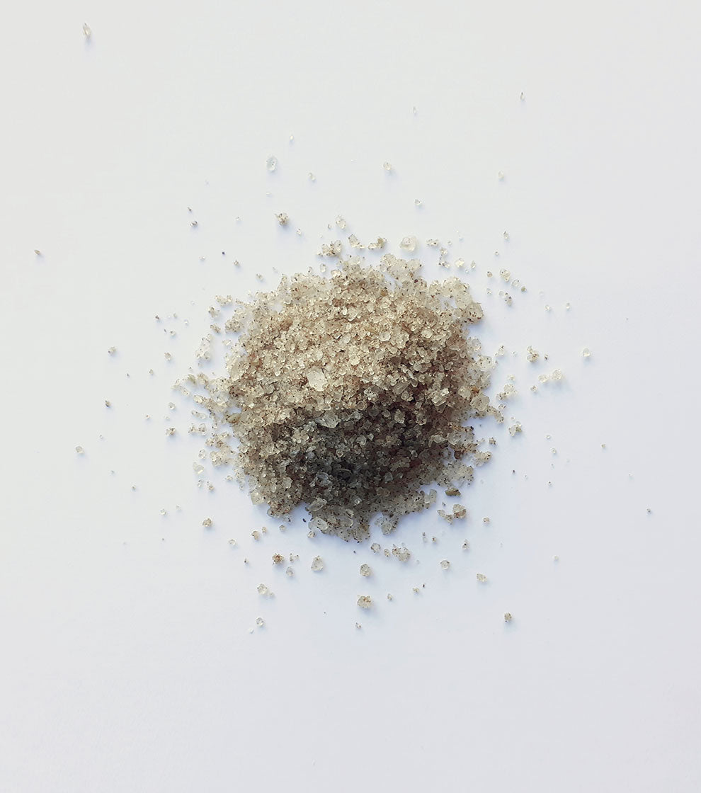 One gray pile of salt side by side on a white background.